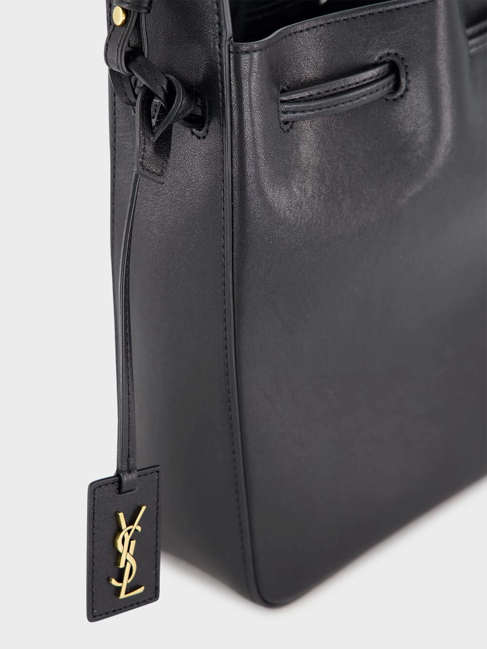 Black Leather Bucket Bag with Cassandre Charm